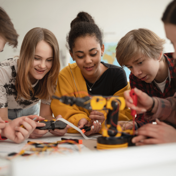 Group of students building and programming electric toys and robots